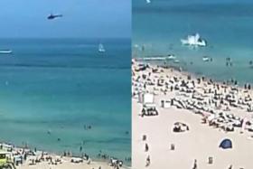 Near miss for Florida beachgoers as helicopter crashes in the sea, injuring two on board
