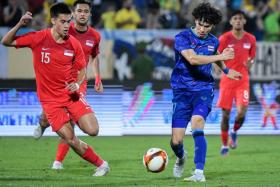Ex-Singapore youth international Ben Davis (blue No.17) in action as Thailand thumped Singapore 5-0 in a football match at the Hanoi SEA Games on May 9. 