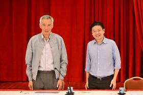 The move will likely see Finance Minister Lawrence Wong (right), PM Lee Hsien Loong's successor, promoted to deputy prime minister. 
