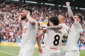 Olivier Giroud (left) celebrates after scoring the second goal against Sassuolo, on May 22, 2022. 
