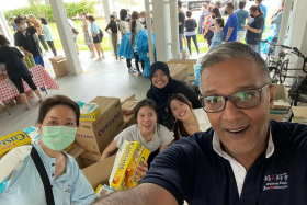 Allen & Gledhill partner Sanjiv Rajan and his team packing food for needy families earlier this year. 