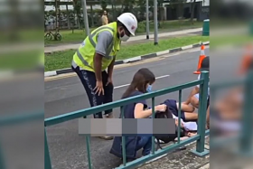 Photos circulating online showed the boy lying on the road in his school uniform while a woman and a construction worker tended to him.