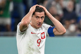Poland forward Robert Lewandowski reacts after missing a penalty against Mexico. 
