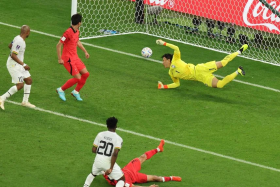 Ghana&#039;s Mohammed Kudus scores his team&#039;s third goal past South Korean goalkeeper Kim Seung-gyu during the FIFA World Cup 2022. 