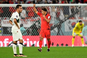 South Korea&#039;s midfielder Hwang Hee-chan celebrates scoring his team&#039;s second goal during the Qatar 2022 World Cup Group H football match between South Korea and Portugal at the Education City Stadium in Al-Rayyan on December 2, 2022.