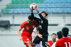 Singapore’s Jordan Emaviwe (left) challenging for the ball with Cambodia goalkeeper Reth Lyheng. ST PHOTO: GAVIN FOO

