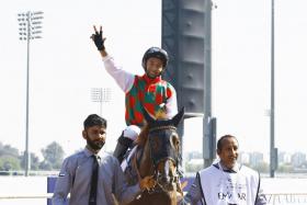 An ecstatic Oscar Chavez acknowledging the cheers from the crowd after scoring the Group 1 Dubai Kahayla Classic on the Majed Al Jahoori-trained Hayyan over 2,000m on dirt at Meydan Racecourse last Saturday. PHOTO: REUTERS
