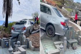 Car reverses into Chinese gravestone in Perak