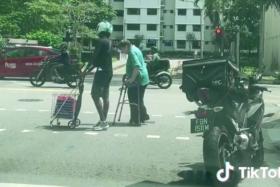 Both crossed the road with the man pushing a shopping trolley and the woman using a walker.