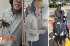 The video shows a young man in a motorcycle helmet and grey hoodie holding a phone and a plastic bag with two containers of food in a lift.