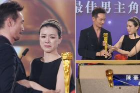 Moses Chan receiving the trophy from his teary wife Aimee.