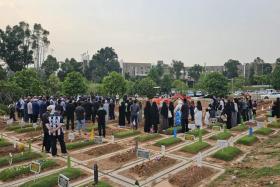 Mourners at the burial of Afifah Munirah Muhammad Azril.