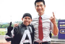 Panamanian jockey Luis Corrales and trainer Richard Lim showing their delight after combining with Combustion to take the Class 5 Division 1 race (1.600m) at Kranji on June 1.
