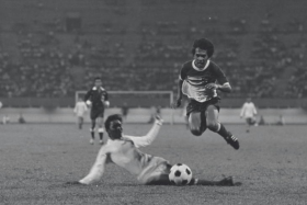 Kelantan&#039;s Ibrahim Zakarian hurdles clear as Singapore centrehalf Hasli Ibrahim traps the ball neatly on the ground in a 1973 game.