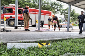 SCDF personnel cleaning up the accident site.