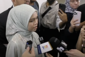 Bella Astillah speaking to local media outside the Syariah Court in Kuala Lumpur.