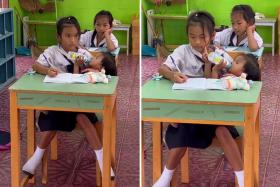 A girl in Thailand has gone viral for juggling school and being a responsible big sister.