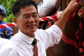 Veteran trainer Leslie Khoo beaming at the winner&#039;s circle after Tennet Tentennet (A&#039;Isisuhairi Kasim) broke his maiden status in a Class 5 race (1,700m) at Kranji on Dec 9, 2023. 
