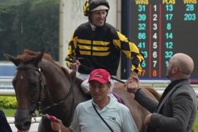 Hugh Bowman getting congratulated by Josh McLoughlan, racing manager of Jig Racing/Elvin Racing Stable after Golden Monkey&#039;s win in the Group 1 Singapore Derby (1,800m) at Kranji on July 23, 2023.