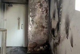 The stairwell of this Yishun HDB block was blackened with soot.