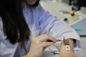 Dr Yang Le, principal scientist at A*Star, with the wearable, stretchable hydrogel-based sensor, which can detect biomarkers such as cholesterol, lactate and glucose.