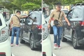 Another driver calmly picks up the discarded peel, knocks on the passenger window to get the occupants&#039; attention, and proceeds to return the trash through the partially opened window.
