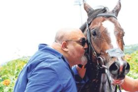 Horse owner Mansoor Gandhi planting a big kiss on Makin after his win in the Class 1 (1,400m) race on Sept 21. On Oct 5, he will pin his hopes on Makin to win Singapore's farewell race, the Grand Singapore Gold Cup (2,000m).