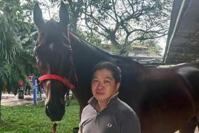 Former Macau-based trainer Ricky Choi Chun Wai with one of his 27 horses stabled at Sungai Besi. He is hoping for a winning start to his Malaysian tenure on Nov 17.
