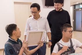 Mr Desmond Choo and Mr Kiat Lim having a discussion with Mr Chong and Mr Leong about their artworks.