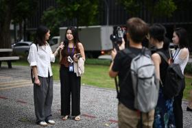 The writer interviewing Ms Jane Fernandez, 23, a market analyst, near Tanjong Pagar MRT station on Dec 17, 2024