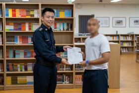 Nabil (not his real name) receiving his O-level results.