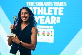 Singaporean track and field athlete Shanti Pereira holding her trophy after winning The Straits Times Athlete of the Year 2023 award at The Straits Times office on May 9. 