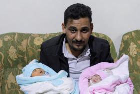 Mr Khalil Al-Sawadi, the uncle-by-marriage of a baby girl born during the Turkey-Syria earthquake, holds her (right) and his own newborn daughter, in Jandaris, Syria, on Feb 18, 2023.
