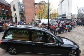 Crowds clapped warmly and held banners as the funeral cortege drove past United’s Old Trafford ground.