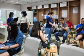 Singapore Population Health Studies staff with participants undergoing health screening at the NUS Saw Swee Hock School of Public Health on Nov 9.