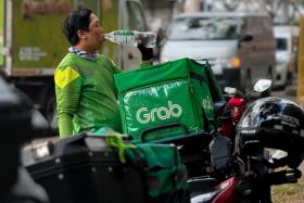 A rider seen taking a drink in this file picture. Some delivery riders said they are avoiding having to work during the hottest part of the day.