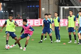 Singapore captain Hariss Harun (left) showing the way during training on Dec 10, the eve of the Lions&#039; Asean Championship opener against Cambodia.