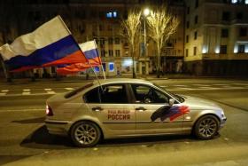 A car with Russia flags attached driving through the separatist-controlled city of Donetsk, Ukraine, on Feb 21, 2022.