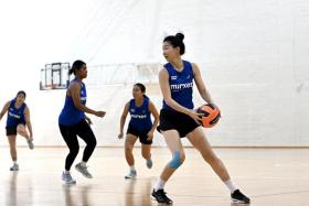 Veteran netballer Charmaine Soh (with ball) is making her return to competitive action after recovering from an anterior cruciate ligament injury. 