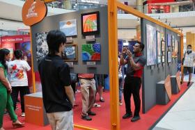 Visitors at the Shaping Hearts roving exhibition in Suntec City on Sept 24.