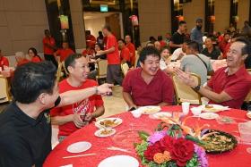 (From right) Senior Minister of State for Manpower Koh Poh Koon with migrant workers Hou Qingcun and Zhang Xiaoliang, who were surprised with video messages from their families at a Chinese New Year dinner on Jan 26.