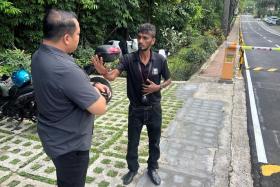 An executive council member of the Union of Security Employees (left) visiting the security officer, identified as Brother Chandra.