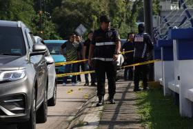 Forensic police officers at the scene of the attack at Ulu Tiram Police Station on May 17.
