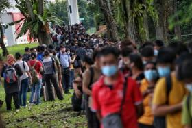 Travellers headed to Malaysia queue to enter Woodlands Checkpoint in Singapore on April 14, 2022. 