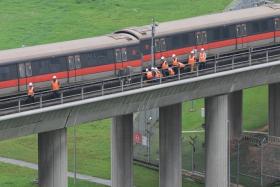 SMRT staff inspecting the carriages of the affected train outside Ulu Pandan Depot at about 1.45pm on Sept 25.