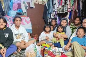 Ms Dayang (right) has been caring for nine grandchildren single-handedly over the past year after her son was jailed for a drug offence.