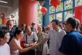 Prime Minister Lawrence Wong greeting patrons at Chinatown Complex on Jan 4.