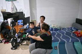 Ms Choo Chang Yan, with her husband, Mr Zhao Wenbin, and their son, Zaleb, at their one-room rental flat.