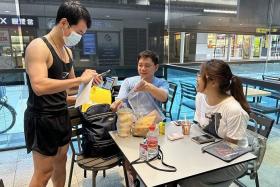 A Malaysian voter in Singapore dropping his ballot off with volunteers from 1ThirdMedia Movement at Paya Lebar Square on Aug 5. 