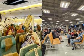 Oxygen masks (left) are seen onboard Singapore Airlines flight SQ321 after an emergency landing at Bangkok's Suvarnabhumi International Airport on May 21.